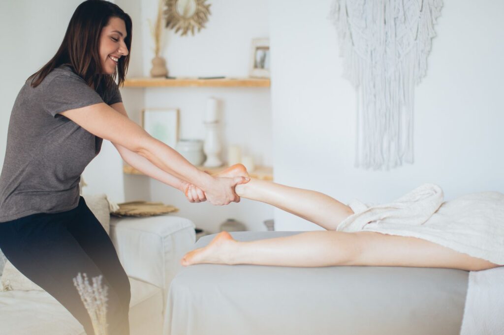 Massage therapist providing a treatment session during a home visit