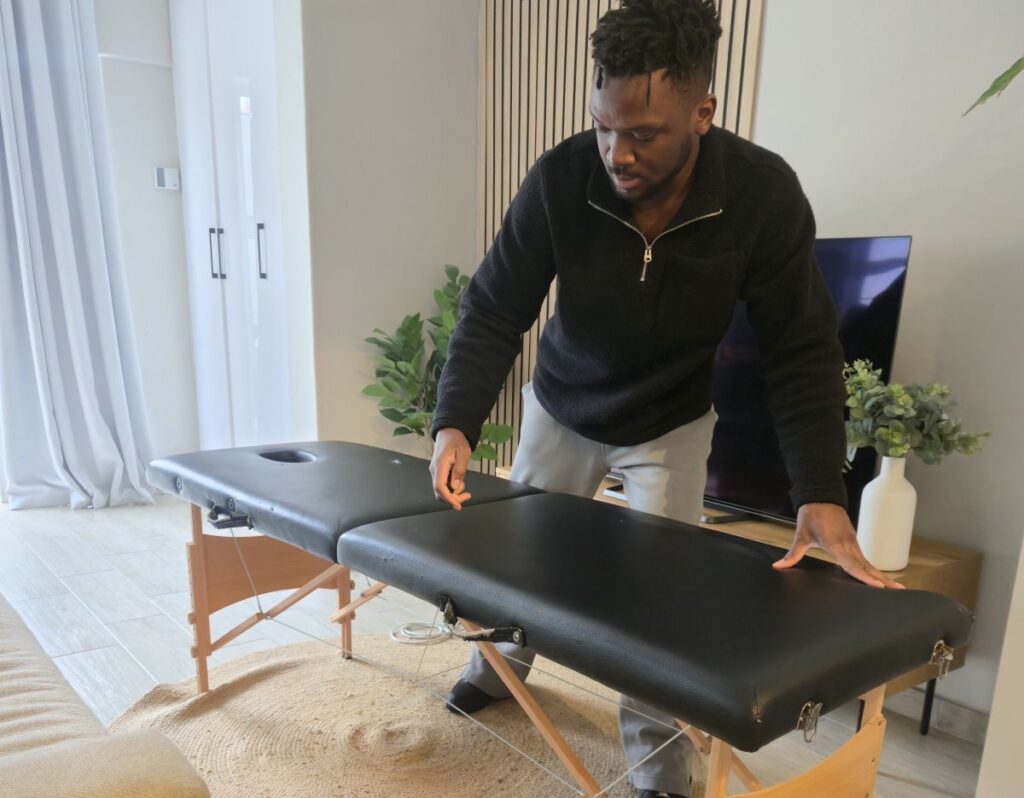 Therapist setting up a massage table for a first mobile massage appointment