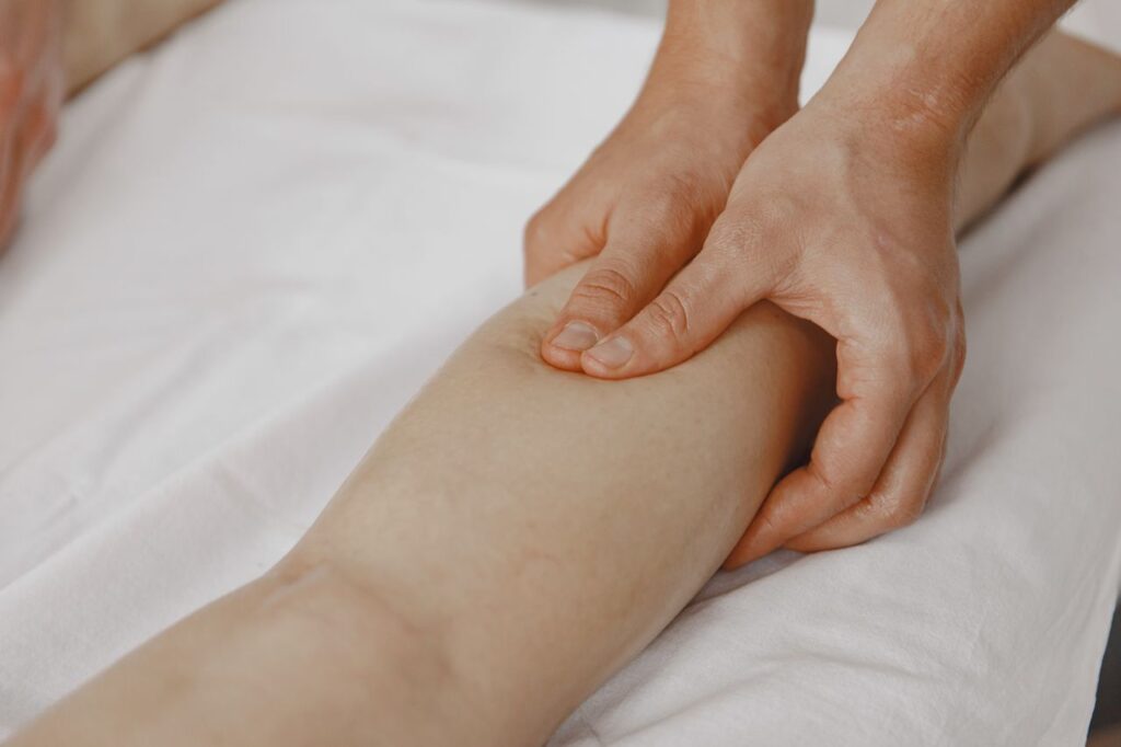 Sports massage treatment on a client's calf muscle